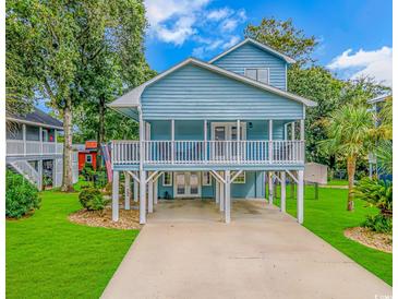 Charming elevated beach home with a spacious covered porch, well-maintained landscaping, and ample parking at 510 21St Ave. N, North Myrtle Beach, SC 29582