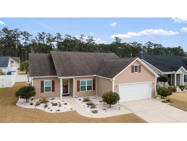 Charming single-story home with well-manicured landscaping and attached garage at 545 Tourmaline Dr., Little River, SC 29566