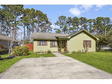 Charming one-story home featuring a well-manicured front yard, and a paved driveway at 11 Ryan Ln., Myrtle Beach, SC 29579