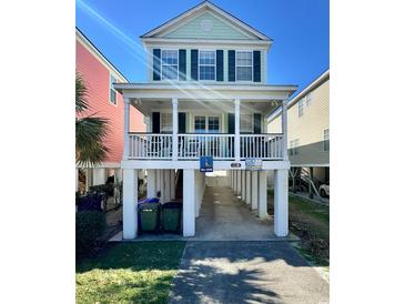 Charming two-story beach house with a welcoming front porch and convenient ground-level parking at 113B 13Th Ave. N, Surfside Beach, SC 29575