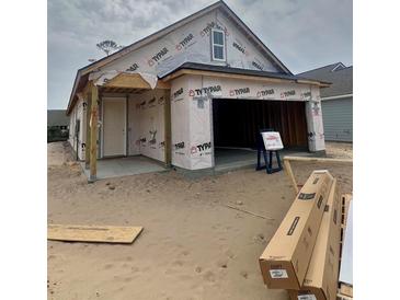 Exterior shot of an unfinished home with a garage and a porch at 1241 Lady Bird Way, North Myrtle Beach, SC 29582