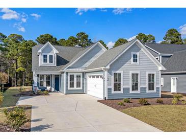 Charming two-story home with a two-car garage, well-maintained landscaping and a welcoming entryway at 136 Starlit Way, Myrtle Beach, SC 29579