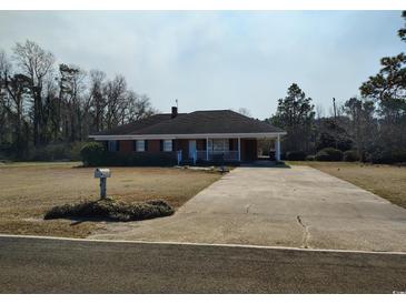 Charming single-story brick home with a covered porch and long driveway at 1375 Kenny Jordan Rd, Tabor City, NC 28463