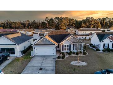 Charming single-story home featuring a two-car garage, landscaped front yard, and neutral exterior at 195 Cupola Dr., Longs, SC 29568