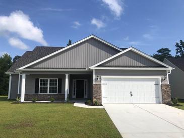 Charming single-story home featuring a gray exterior, attached two-car garage, and manicured front lawn at 276 Stillbrook Dr., Longs, SC 29568