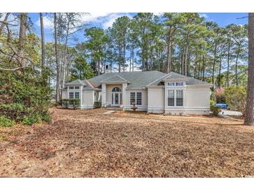 Charming single-story home with a well-maintained front yard and large windows at 3026 Cedar Creek Run, Little River, SC 29566