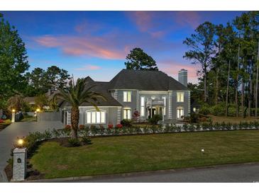Beautiful gray home featuring lush landscaping and a well manicured front lawn at 3700 Waterford Dr., Myrtle Beach, SC 29577