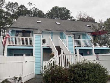 Charming two-story exterior with light blue wood paneling, white railings, and staircase at 405 Cambridge Circle # B5, Murrells Inlet, SC 29576