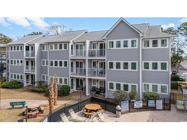 Beautiful building with multiple balconies and access to a community pool, creating an inviting outdoor space at 5905 South Kings Hwy. # 4219-D, Myrtle Beach, SC 29575