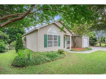 Charming single-story home with green shutters, lush landscaping and inviting curb appeal at 6006 Quinn Rd., Myrtle Beach, SC 29579