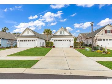 Charming single-story home featuring a two-car garage, manicured lawn, and beautiful landscaping at 6069 Tramonto St., Myrtle Beach, SC 29572