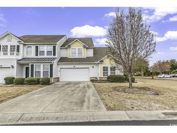 Home exterior featuring a two-car garage, well-maintained landscaping, and an inviting driveway at 6203 Catalina Dr. # 2316, North Myrtle Beach, SC 29582