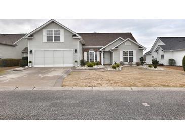 Charming one-story home with attached two-car garage and manicured front yard featuring flowerbeds at 807 Lalton Dr., Conway, SC 29526