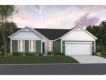 Charming single-story home boasts a welcoming front yard, attached two-car garage and a delightful green color scheme at 85 Northbrook Dr, Murrells Inlet, SC 29576