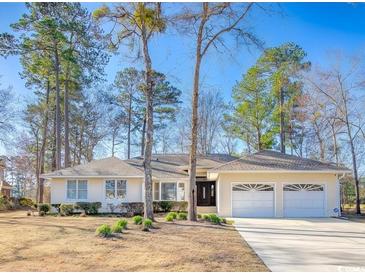 Charming single-story home with a two-car garage, well-manicured lawn, and mature trees in a quiet setting at 1043 Yellow Jasmine Dr., Longs, SC 29568