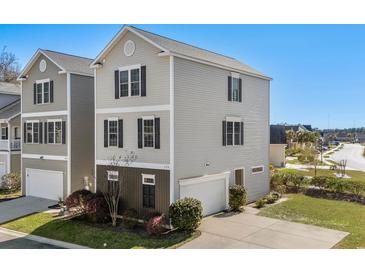 Two-story home with grey siding, black shutters, an attached garage, and a well-manicured front yard at 159 Terracina Circle, Myrtle Beach, SC 29588