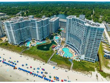 Stunning aerial view of beachfront resort with multiple pools and ocean access at 161 Seawatch Dr. # 808, Myrtle Beach, SC 29572