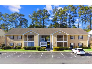 Inviting condo exterior with ample parking, landscaping, and screened-in porch at 197 Charter Dr. # D-8, Longs, SC 29568