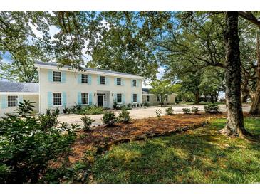 Charming two-story home with blue shutters and mature landscaping at 201 River Rd., Georgetown, SC 29440