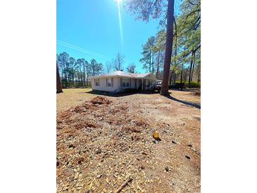 Charming single-story home with a well-maintained front yard and a backdrop of mature trees, offering privacy and curb appeal at 3302 Highway 905, Conway, SC 29526