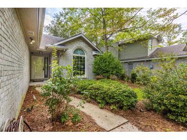 Charming home with a well-manicured front yard and a welcoming entrance at 409 65Th Ave. N, Myrtle Beach, SC 29572