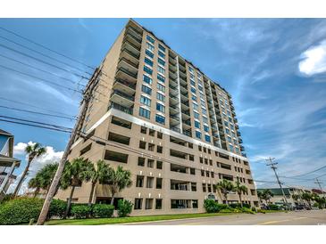 Multi-story condo building featuring private balconies, parking garage and nearby palm trees, under a blue partly cloudy sky at 4103 N Ocean Blvd. # 304, North Myrtle Beach, SC 29582