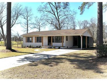 Charming single-story home with a brick exterior, shuttered windows, and well-maintained front yard and driveway at 4320 Stevens St., Loris, SC 29569