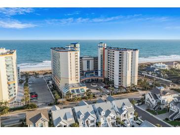 Expansive aerial view of a beachfront condo building with beautiful ocean views and surrounding neighborhood at 5200 N Ocean Blvd. # 937, Myrtle Beach, SC 29577