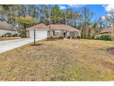 Charming single-story home with a well-manicured lawn and attached two-car garage at 540 Alderly Ct., Little River, SC 29566