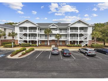 Condo building featuring multiple stories, exterior stairs, and well-kept landscaping at 6015 Catalina Dr. # 914, North Myrtle Beach, SC 29582