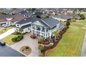 Aerial view of a beautiful traditional home featuring double balconies, mature landscaping, and circular driveway at 898 Bluffview Dr., Myrtle Beach, SC 29579