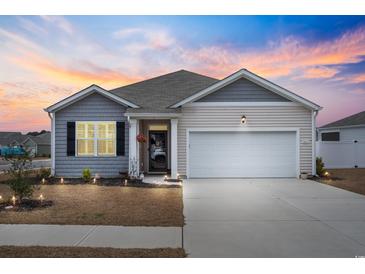 Charming single-story home with a two-car garage, tidy landscaping, and inviting curb appeal during a vibrant sunset at 1061 Sennema Circle, Myrtle Beach, SC 29588