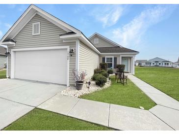 Charming one-story home with a two-car garage, neat landscaping, and a well-manicured lawn at 1908 Gasparilla Ct., Myrtle Beach, SC 29588