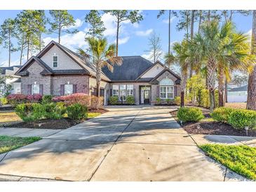 Charming brick home with a long driveway and manicured landscaping with palm trees at 2840 Mcleod Ln., Myrtle Beach, SC 29588