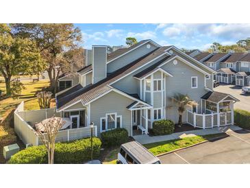 Charming condo with well-maintained landscaping and a cozy outdoor seating area; ample parking available at 435 Ocean Creek Dr. # 2705, Myrtle Beach, SC 29572