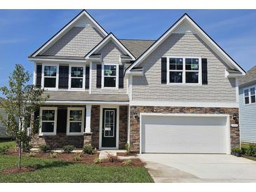 Charming two-story home with gray siding, stone accents, and a well-manicured front yard at 534 Haven View Way, Murrells Inlet, SC 29576