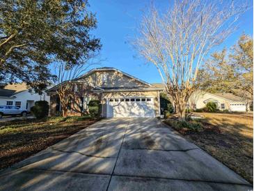 Charming home featuring a long drive, two-car garage, and a mix of brick and siding at 80-2 Knight Circle # 2, Pawleys Island, SC 29585