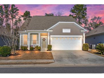 Charming single Gathering home featuring a two-car garage and a well-manicured lawn at 1186 Pyxie Moss Dr., Little River, SC 29566