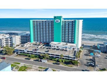 Aerial view of a multi-story hotel with ocean views and a parking garage at 1210 N Waccamaw Dr. # 1507, Murrells Inlet, SC 29576