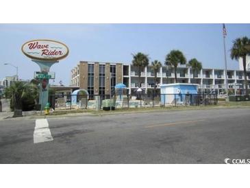 View of the Wave Rider hotel with swimming pool and palm trees at 1600 S Ocean Blvd. # 148, Myrtle Beach, SC 29577