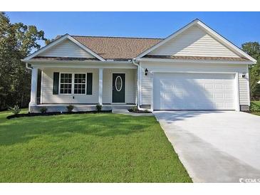 Charming single-story home with a well-manicured lawn and an attached two-car garage at 2315 Withers St., Georgetown, SC 29440