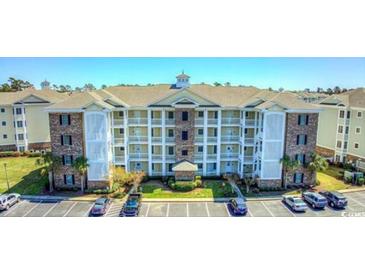 Beautiful condo building with stone accents and well maintained landscaping in a community with ample parking at 4865 Luster Leaf Circle # 402, Myrtle Beach, SC 29577