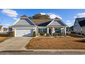 Charming single-story home with a well-maintained lawn, attached garage, and decorative shutters at 509 Hillsborough Dr., Conway, SC 29526