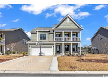 Charming two-story home with a welcoming porch and well-maintained lawn and a basketball hoop over the garage at 546 Calhoun Falls Dr., Myrtle Beach, SC 29577