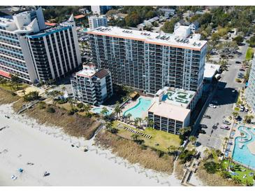 Stunning aerial view of the beachfront resort featuring pools, palm trees, and pristine sandy beach at 7200 Ocean Blvd. N # 1059, Myrtle Beach, SC 29572
