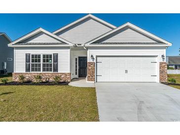 Charming single-Gathering home featuring a two-car garage, and a well-manicured lawn, perfect for curb appeal at 415 Lifestyle Court, Surfside Beach, SC 29575