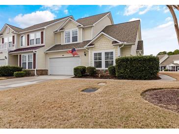 Inviting two-story townhouse with attached garage and well-maintained front lawn in a residential neighborhood at 6095 Catalina Dr. # 1314, North Myrtle Beach, SC 29582