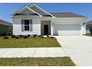 Charming single-story home featuring a well-manicured lawn and an attached two-car garage at 8628 Farrier Dr., Myrtle Beach, SC 29588