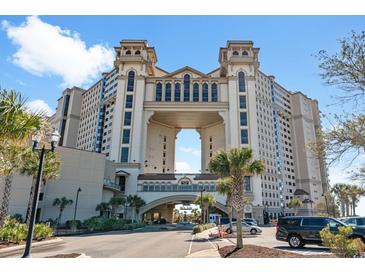 Stunning multi-story building showcasing unique architectural design with arched entrance and ample parking at 100 N Beach Blvd. # 1608, North Myrtle Beach, SC 29582