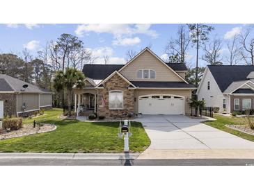 Charming home featuring a stone facade, well-manicured lawn, and a two-car garage in a desirable neighborhood at 120 Swallowtail Ct., Little River, SC 29566